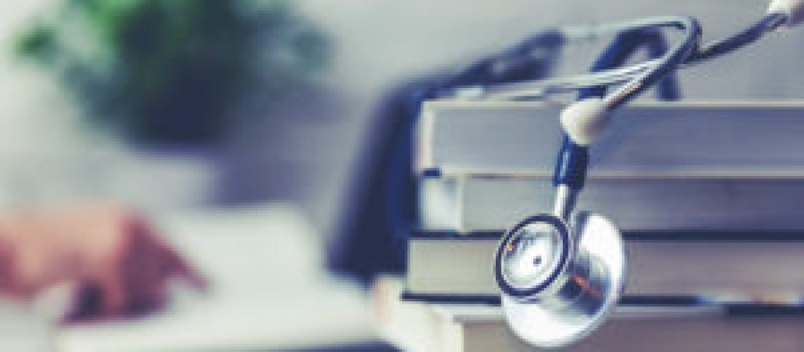 medical college student with stack of books