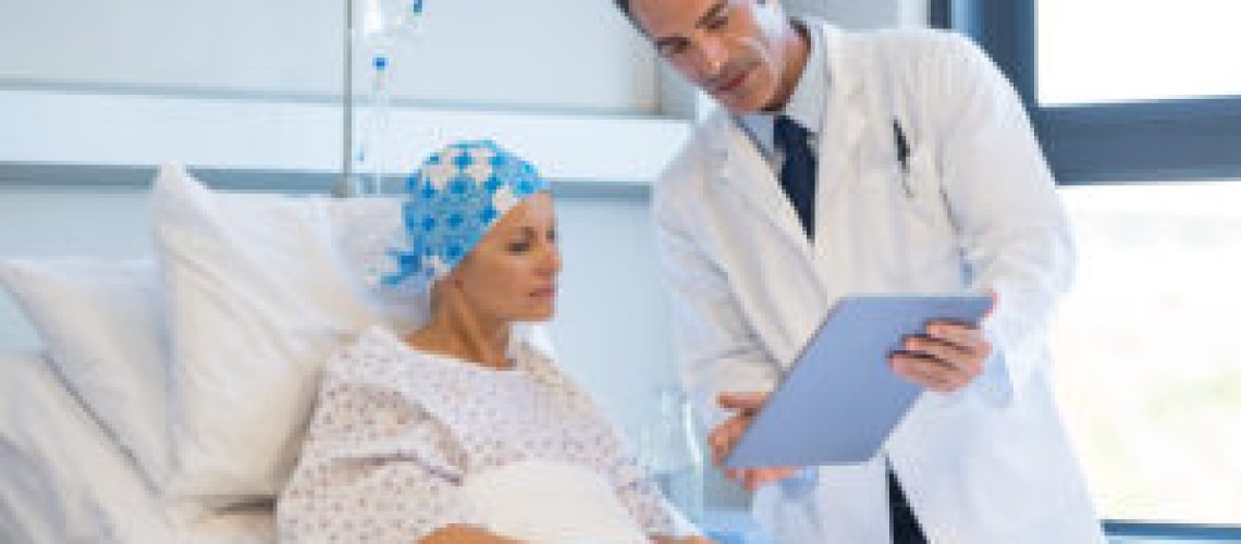 Doctor telling to patient woman the results of her medical tests. Doctor showing medical records to cancer patient in hospital ward. Senior doctor explaint the side effects of the intervention.
