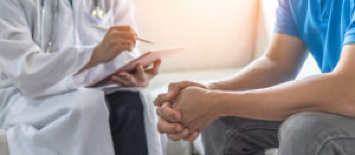 Men's health exam with doctor or psychiatrist working with patient having consultation on diagnostic examination on male disease or mental illness in medical clinic or hospital mental health service